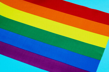 Close up of rainbow flag on blue background