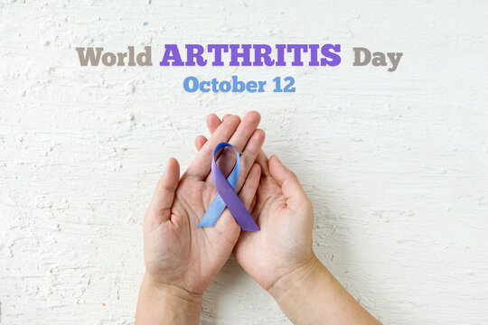 World Autoimmune Arthritis Day. The blue-purple ribbon in the hands of a woman is symbol of fight against Arthritis