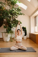 Foto op Plexiglas Young white woman doing exercise on mat during yoga practice © Drobot Dean
