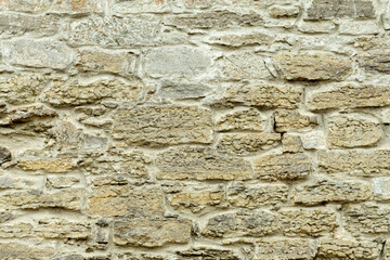 Sturdy yellow and beige cut stone wall, good for backgrounds