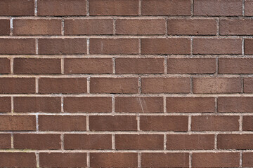 The texture of a neat brown stone. Smooth brickwork with brown smooth stone. The texture of the wall of the English house.