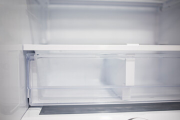 Transparent clean refrigerator shelves after cleaning. Freshness area in the refrigerator. Empty refrigerator. Poverty crisis unemployment