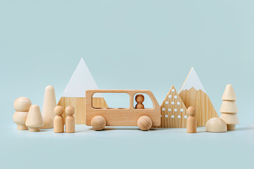 Wooden play set forest, mountains and a bus on a blue background. Games for learning and...