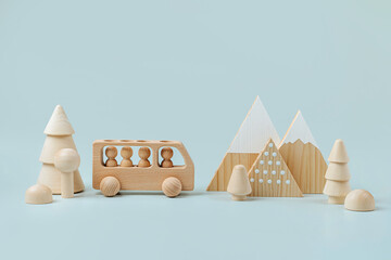 Wooden play set forest, mountains and a bus on a blue background. Games for learning and development of the child. Cute kids toys  for decorating children's room.