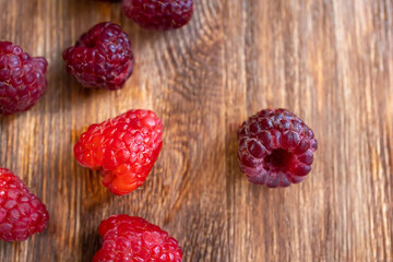top view of berries scattered on a wooden table raspberries on the table