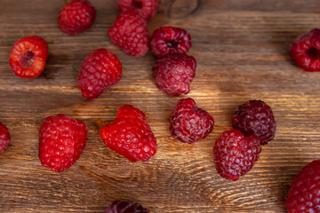 top view of raspberries scattered on wooden table