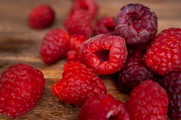 a small bunch of juicy raspberries on a wooden table