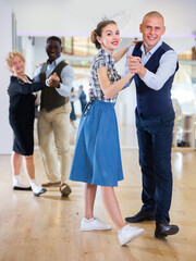 Adult dancing couple enjoying active swing