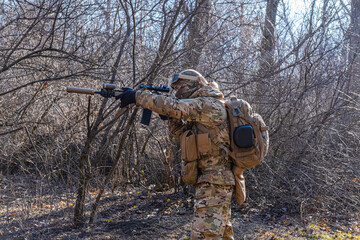 Male modern soldier in the autumn forest 