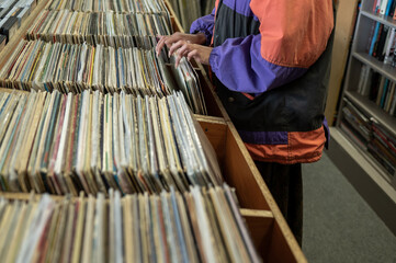 Woman seen searching through vinyl records