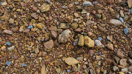 River stones background. Close-up of a natural river bank stone in a mountain forest in central Thailand. Stone and ecology concept.