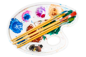 Paintbrush set on the art palette with stains of watercolor paint