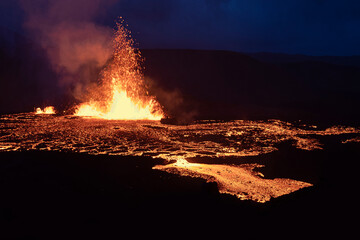 Volcano eruption at Meradalir near Fagradalsfjall, Iceland. Erupting magma and flowing lava at...