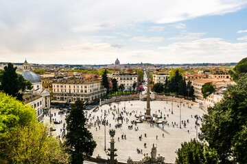 Fototapeta na wymiar View of the Piazza del Popolo with people walking and blue sky. Rome City, Italy