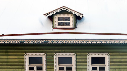 Frozen attic window in the roof covered with snow