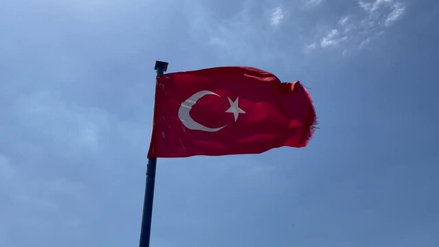 Flying Turkish National Flag on blue sky background, Turkish Flag (AKA Türk Bayrağı) waving in the wind.