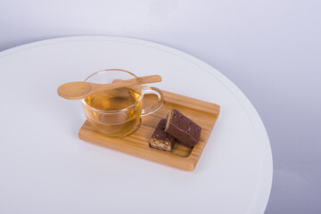 The cup of tea is on the white table