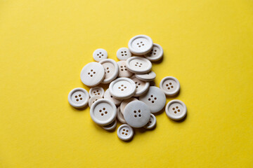 a lot of wooden buttons on a yellow background