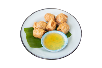 Hoi jo crab rolls or crab jujube placed on a green banana leaf in a tiled dish isolated on cut out PNG or transparent background.. Thai people called Hoi-cho local traditional style.