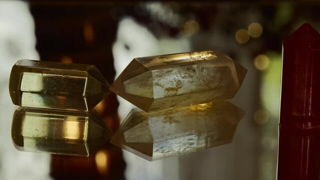 Three crystals can be seen placed on a mirror plate. In the background is the silhouette of the Leaning Tower of Pizza.