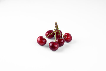 Sweet cherry. On a Bunch of cherries with a leaf. On a white background