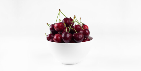 Sweet cherry. Cherries in a bowl. On a white background.