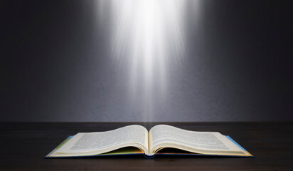 Open Bible. Holy Bible on the table. Light from a book.