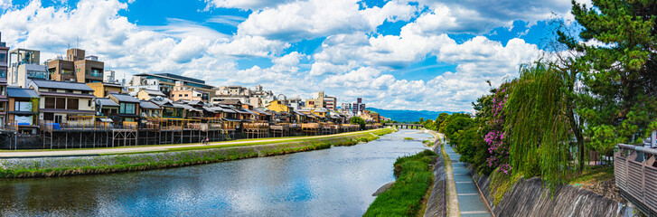 Panoramic view of Kyoto Kamo river -Kamogawa- river side view under dynamic blue sky in Kyoto, Japan.