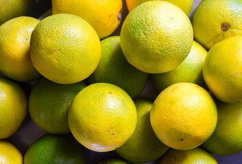 Fresh orange fruits seamless background. Lime, tangerine or citrus fruits.