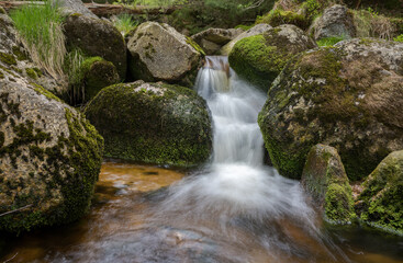 Naklejka na ściany i meble cascade on a mountain stream - water in motion - long exposure