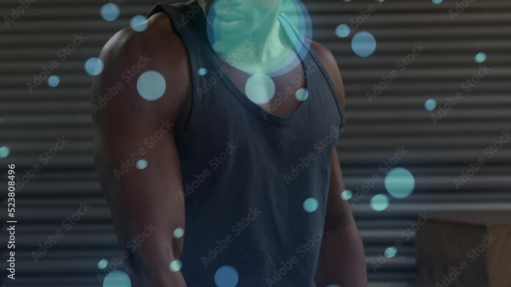 Poster animation of bokeh effect against african man building muscles with dumbbell in gym