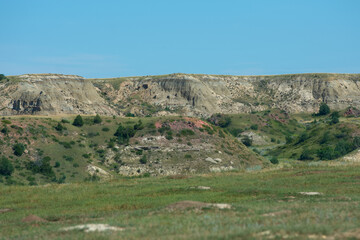 Fototapeta na wymiar Multi colored and layered rock hills at Theodore Roosevelt National Park