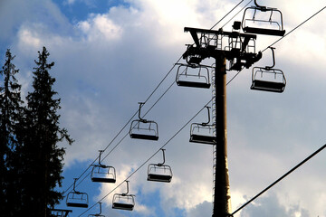 Cable car support pillar with empty chairs on cables
