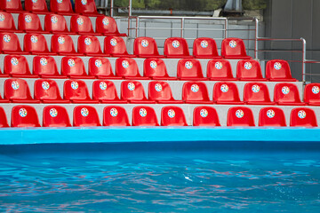 Empty, red bleachers before the performance in the pool
