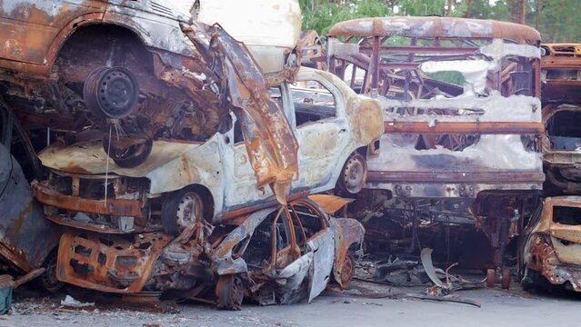 Russian invasion of Ukraine in 2022, destroyed and burned cars. The cars were beaten with shrapnel and burned. Irpinsky automobile cemetery. Consequences of the war in a peaceful city near Kyiv.