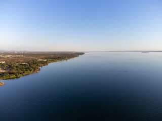 Green piece of land with trees on the banks of the great lake of the Tocantins River in Palmas