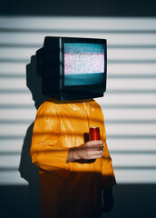 Surreal art of TV addicted man with television instead of head.