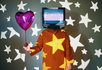 Surreal art of TV addicted man with tv instead of head holding helium balloon on party.