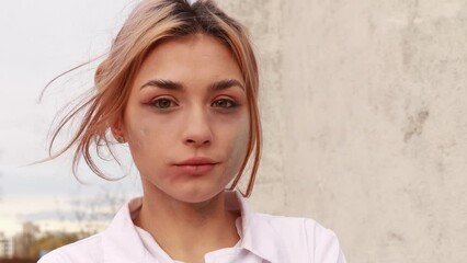 Dirty tired exhausted nurse with ash on face outside hospital infirmary after hard working day or surgery. Doctor woman dressed white medical gown, face mask have a rest due to stress