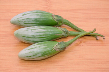 Green eggplant on the wooden background.Healthy natural food.