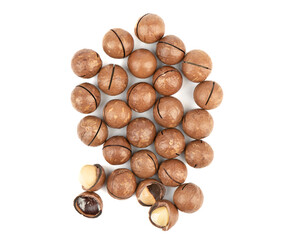 Peeled and unpeeled macadamia nuts on a white background.