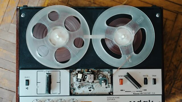 Turning off an old reel to reel tape recorder that was turned on for playback.