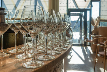 Empty wine glasses lined up on the cafe bar, close up