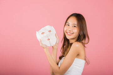 Healthcare spa. Asian woman holding purifying mask face on hands, Portrait beautiful female smiling...