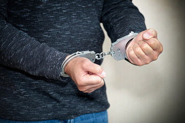 The hijacker in handcuffs at the scene of the crime was detained by the police. Crime, car theft.