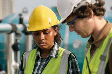 Two Professional engineer man and women working checking and maintenance pipeline construction top...