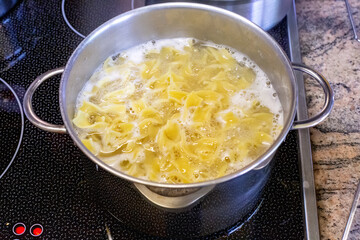 close-up of a stove with pot and pasta