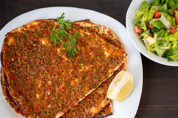 Lahmacun; Turkish pizza with salad on wooden table