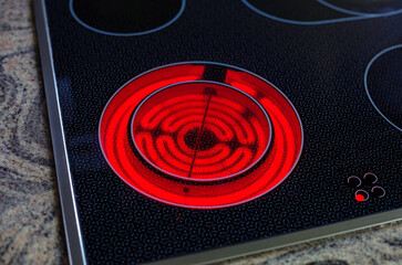close-up of a round red glowing induction stove