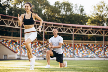 Obraz premium Couple exercising using elastic rope